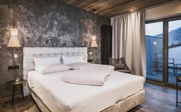 Panorama Restaurant Hotel Margarethenstein gemütliches Bett in der Auszeit Suite im Design Hotel Margarethenstein