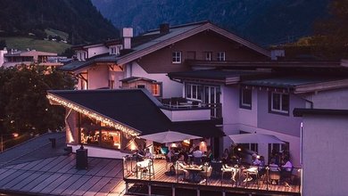 Terrace with lounge area in the evening in Panorama Restaurant in Kaprun